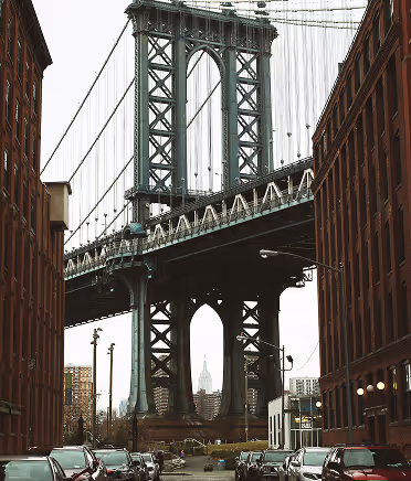 Manhattan Bridge framed by red-brick buildings in Dumbo, Brooklyn.