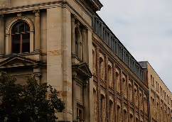 Historic stone building with arched windows.