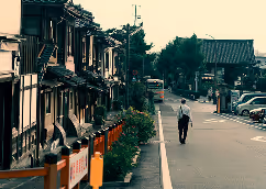 Person walking down a quiet street.