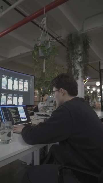 Tim coding at his desk.